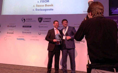 Saxo Bank's Kim Fournais being presented with the Forex Magnates Award for Best Broker by Michael Greenberg