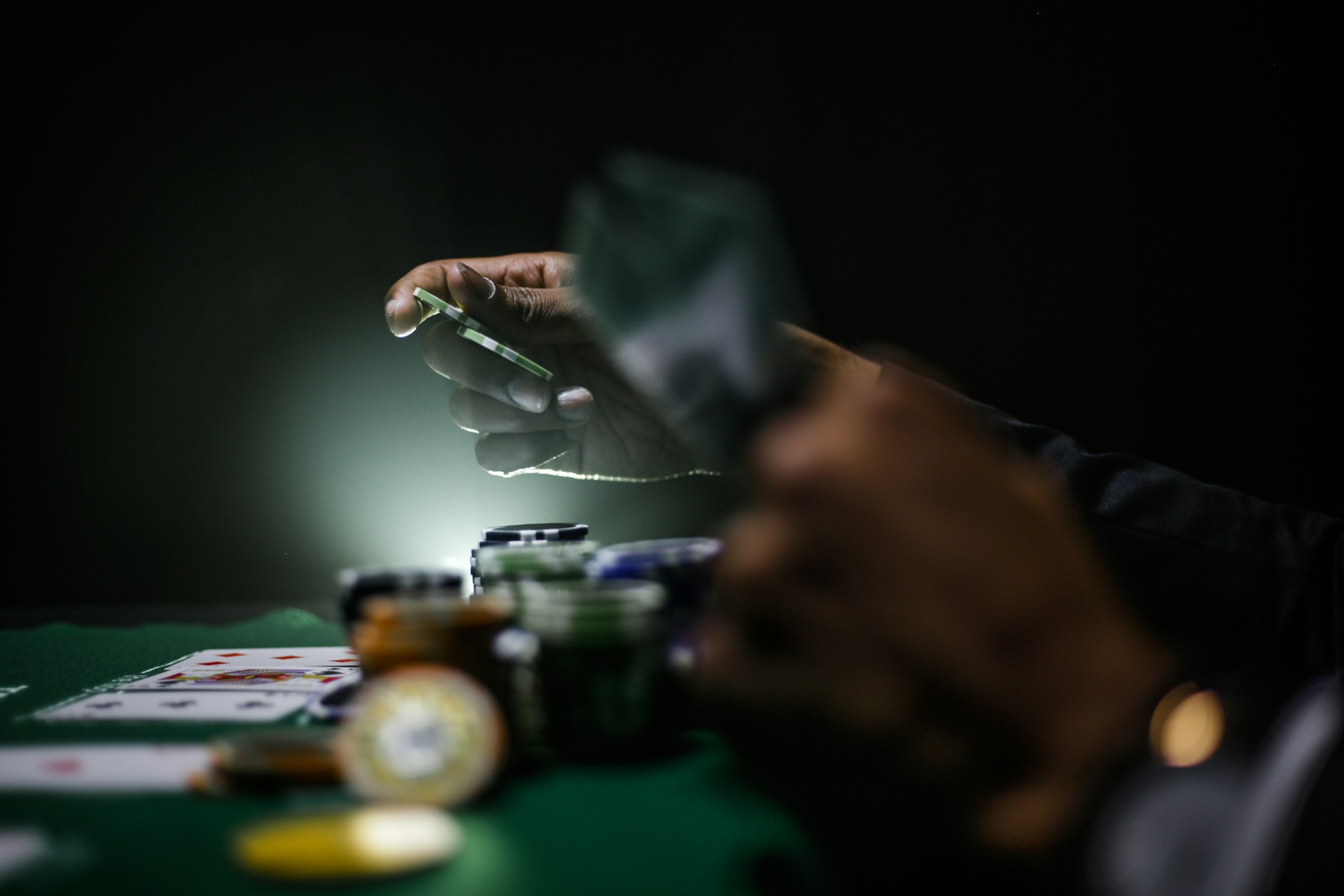 Alt: A person playing with poker chips and cards.