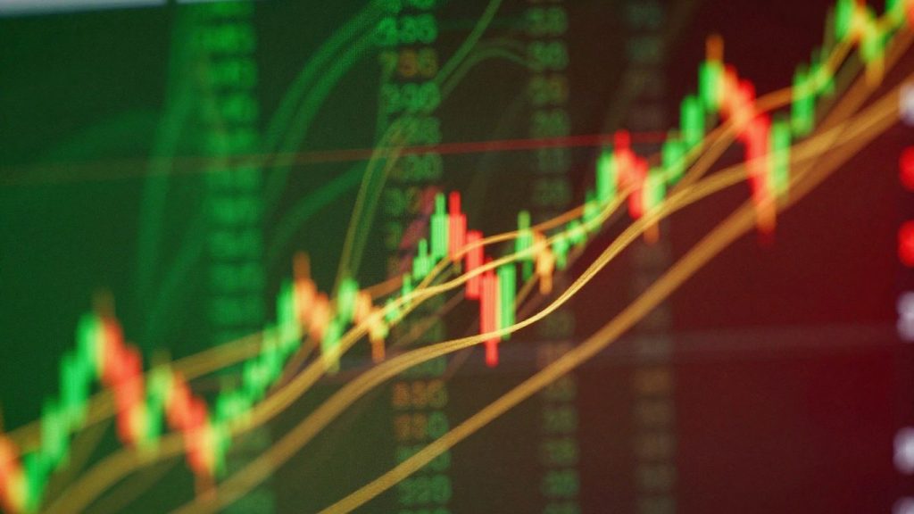 Abstract financial market patterns with green and red hues.