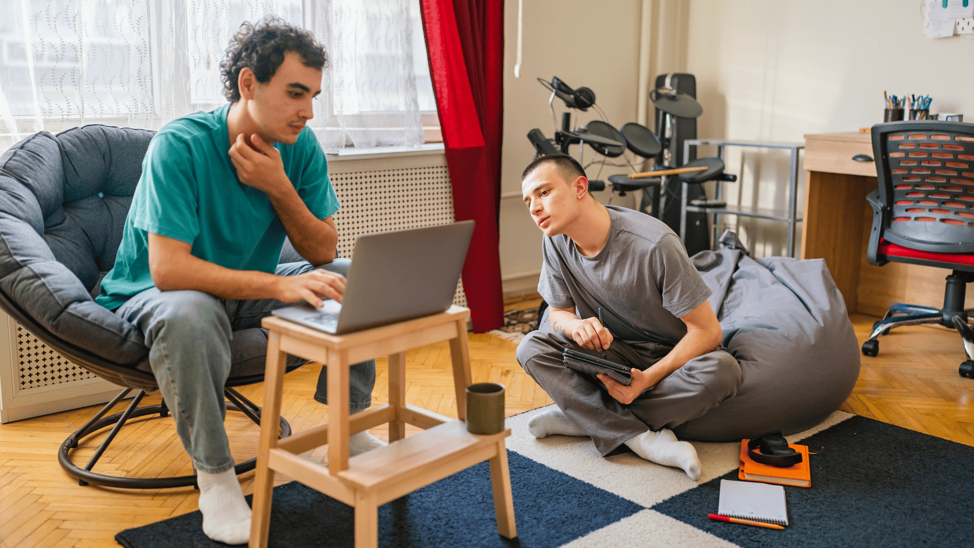 Roommates Sitting in Living Room Looking at Laptop