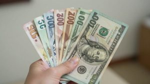 International currency bills held in hand